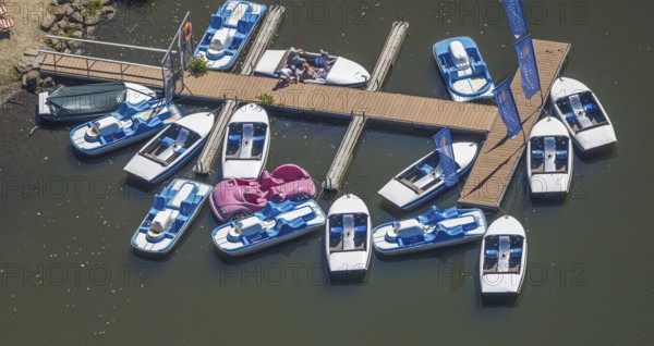 Aerial view, pedal boats at the landing stage at the Biggesee boathouse, people in the boat, shapes and colours, Olpe town, Olpe, Sauerland, North Rhine-Westphalia, Germany