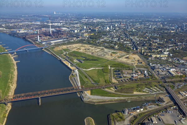 Aerial view, Rheinpark Duisburg on the river Rhine and planned residential complex RheinOrt Hochfeld, future IGA site, historic Hochfeld railway bridge and bridge of solidarity with red railings, distant view, Hochfeld, Duisburg, Ruhr area, North Rhine-Westphalia, Germany