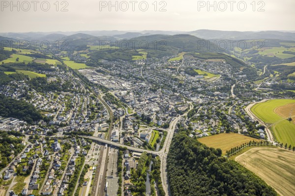 Aerial view, townscape with federal road B55 Antoniusbrücke and railway station, hilly landscape, Meschede city, Meschede, Sauerland, North Rhine-Westphalia, Germany, railway area, railway station, platform, DE, Deutsche Bahn AG, Europe, railway tracks, tracks, property tax, central station, main station, real estate, aerial view, aerial photography, aerial photography, Ruhr area, overview, bird's-eye view, residential area, living and living, residential area, residential quality, residential neighbourhood, residential estate, residential district, birds-eyes view, overview