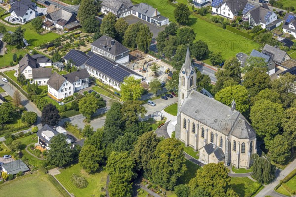 Aerial view, St. Pankratius cath. Church, Raphaelschule Eslohe - Reiste sub-location with solar roof, construction site, Reiste, Eslohe, Sauerland, North Rhine-Westphalia, Germany, place of worship, construction work, construction area, building site, building plots, construction project, education, educational institution, DE, roof with solar panels, Europe, religious community, place of worship, sacred site, church, parish, denomination, educational institute, aerial view, aerial photography, aerial photography, Meschede, photovoltaic system, religion, religious site, Ruhr area, school, solar, solar system, solar roof, solar energy, solar panels, solar power system, overview, bird's-eye view, overview