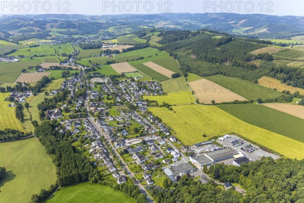 Aerial view, residential area local view district Reiste, meadows and fields and distant view with hilly landscape, Reiste, Eslohe, Sauerland, North Rhine-Westphalia, Germany, DE, Europe, property tax, hilly landscape and distant view, real estate, aerial view, aerial photography, aerial photography, Meschede, Ruhr area, overview, bird's-eye view, meadows and fields, meadow area, meadow landscape, housing estate, housing and living, residential area, quality of living, residential neighbourhood, housing estate, residential area, birds-eyes view, overview
