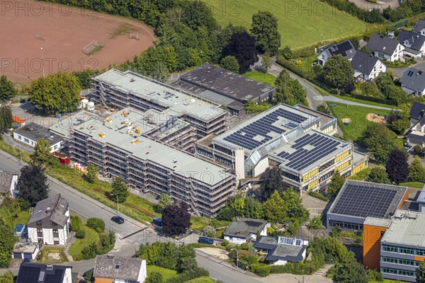 Aerial view, August-Macke-Schulzentrum, St. Walburga catholic secondary school and St. Walburga Realschule Meschede with solar roof, construction site with scaffolding, Meschede town, Meschede, Sauerland, North Rhine-Westphalia, Germany, construction work, construction area, building site, building plots, construction project, construction site, education, educational institution, DE, Europe, secondary school, teaching institute, aerial photograph, aerial photography, aerial photography, new building, secondary school, Ruhr area, school, overview, bird's eye view, birds-eyes view, overview