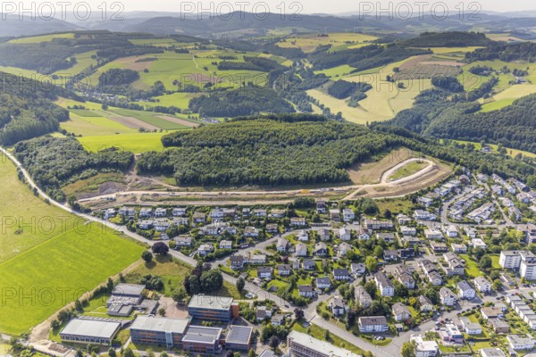 Aerial view, construction site, construction road An der Sündelt for planned new development area, hilly landscape with distant view, Meschede town, Meschede, Sauerland, North Rhine-Westphalia, Germany, construction work, construction area, building site, building plots, construction project, construction site, DE, Europe, large construction site, aerial view, aerial photography, aerial photography, new construction, Ruhr area, overview, bird's-eye view, bird's-eye view, overview