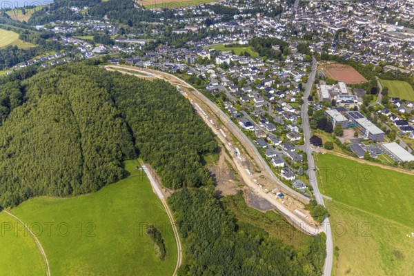 Aerial view, construction site, construction road An der Sündelt for planned new development area, Meschede-Stadt, Meschede, Sauerland, North Rhine-Westphalia, Germany, construction work, construction area, building site, building plots, construction project, construction site, DE, Europe, large construction site, aerial photograph, aerial photography, aerial photography, new construction, Ruhr area, overview, bird's-eye view, bird's-eye view, overview