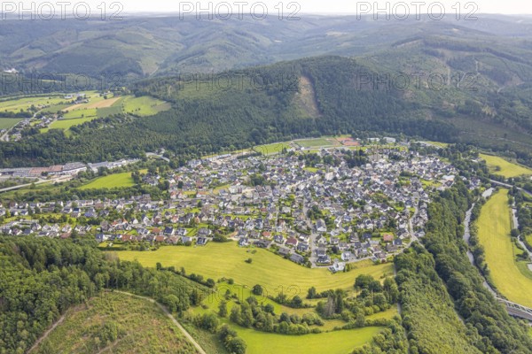 Aerial view, residential area local view Freienohl at the main street with catholic St. Nikolaus parish church, Meschede, Sauerland, North Rhine-Westphalia, Germany, place of worship, DE, Europe, religious community, place of worship, property tax, holy place, real estate, church, parish, denomination, aerial view, aerial photography, aerial photography, religion, religious site, Ruhr area, overview, bird's eye view, residential area, living and life, residential area, quality of life, residential neighbourhood, housing estate, residential district, birds-eyes view, overview