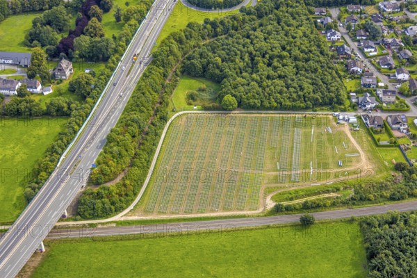 Aerial view, construction of a solar park next to the A46 motorway, Hermannswiese, Wennemen, Meschede, Sauerland, North Rhine-Westphalia, Germany, motorway, construction work, construction area, building site, building plots, construction project, construction site, DE, Europe, photovoltaics, aerial view, aerial photography, aerial photography, new construction, photovoltaic plant, Ruhr area, solar, solar plant, solar energy, solar power plant, overview, bird's eye view, birds-eyes view, overview