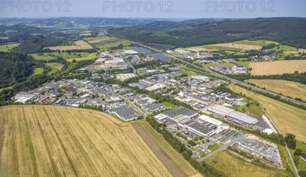 Aerial view, general view of the Enste industrial estate, citizen solar park photovoltaic solar power plant on the A46 motorway and forest, Enste, Meschede, Sauerland, North Rhine-Westphalia, Germany, DE, Europe, commercial enterprise, commercial space, commercial area, commercial property, industrial park, commercial location, commercial use, industrial area, industrial location, aerial view, aerial photography, aerial photography, photovoltaic plant, Ruhr area, solar, solar plant, solar energy, solar park, solar power plant, overview, bird's-eye view, birds-eyes view, overview