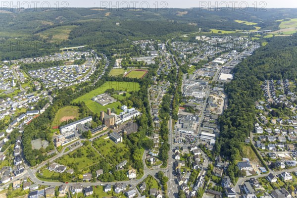Aerial view, Königsmünster Abbey, Dünnefeld stadium with vocational college, Jahnstraße Im Schwarzen Bruch industrial estate with South Westphalia University of Applied Sciences, Am Ziegeleiteich residential area, Meschede town, Meschede, Sauerland, North Rhine-Westphalia, Germany, education, educational institution, DE, Europe, football, football pitch, football stadium, commercial enterprise, commercial area, industrial estate, commercial property, commercial park, commercial location, commercial use, property tax, university, real estate, industrial area, industrial location, educational institute, aerial view, aerial photography, aerial photography, Ruhr area, sport, sports facility, sports field, overview, bird's-eye view, residential area, living and living, residential area, residential quality, residential neighbourhood, housing estate, residential area, birds-eyes view, overview