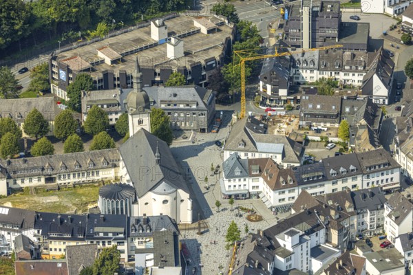 Aerial view, Stiftsplatz with St. Walburga catholic church, behind car park Stiftsplatz with parking deck, construction site and construction crane with new building at Kaiser-Otto-Platz, Meschede-Stadt, Meschede, Sauerland, North Rhine-Westphalia, Germany, place of worship, construction work, construction area, building site, building plots, construction project, construction project, construction site, DE, Europe, religious community, place of worship, holy place, church, parish, denomination, aerial view, aerial photography, aerial photography, new building, religion, religious site, Ruhr area, overview, bird's-eye view, birds-eyes view, overview