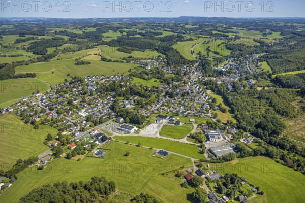 Aerial view, residential area local view district Rönsahl with historical distillery Rönsahl, sight, in front Netto supermarket with solar roof and Ernst Wilhelm Julius GmbH, Meienborn, hilly landscape with distant view, Rönsahl, Kierspe, Sauerland, North Rhine-Westphalia, Germany, DE, roof with solar panels, Europe, property tax, real estate, aerial view, aerial photography, aerial photography, photovoltaic plant, Ruhr area, chimney, solar, solar plant, solar roof, solar energy, solar panels, solar power plant, overview, bird's eye view, residential complex, living and life, residential area, residential quality, residential neighbourhood, housing estate, residential district, birds-eyes view, overview