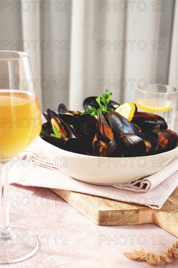 Boiled mussels, on a light table, with wine and lemon, homemade, no people