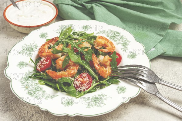 Shrimp salad with arugula and cherry tomatoes, with parmesan cheese, healthy food