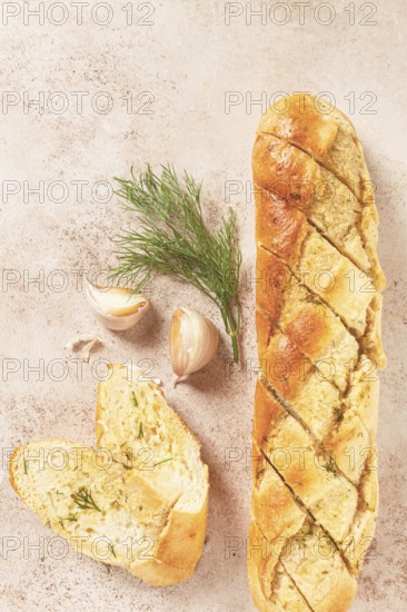 Freshly baked garlic bread with herbs and garlic on a light countertop