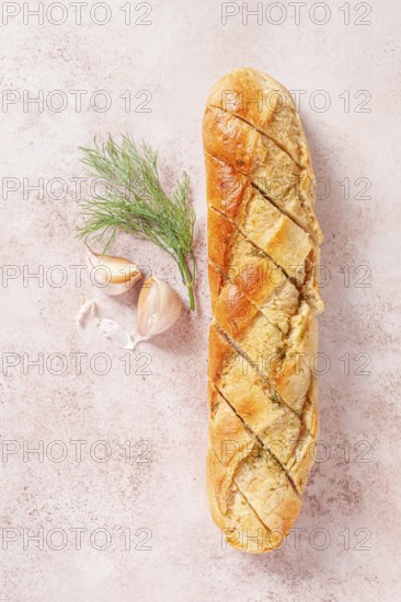 Freshly baked garlic bread with herbs and garlic on a light countertop