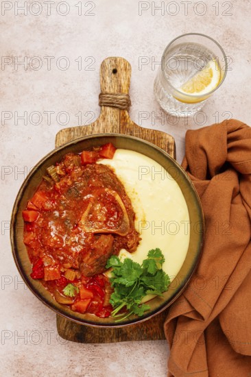Ossobuco, stewed meat knuckle on the bone, with mashed potatoes, and oats and spices, homemade, no people