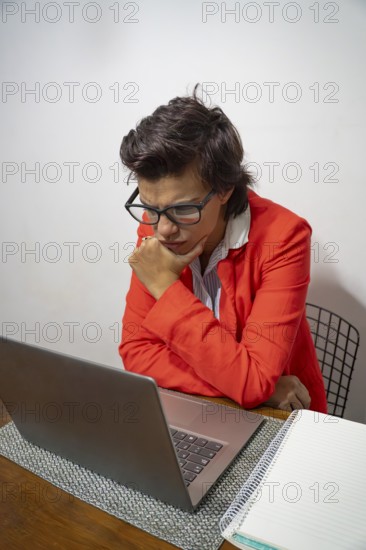 Thoughtful businesswoman working from her home desk