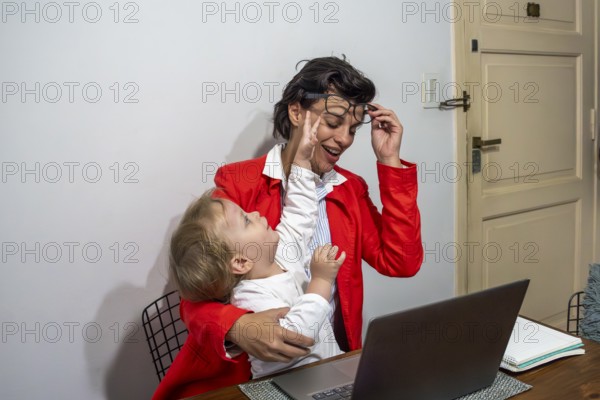 Authentic moment of a parent trying to focus on work