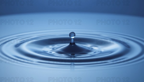 A captivating image of a water droplet creating ripples on a smooth, reflective blue surface, showcasing natural beauty, AI generated