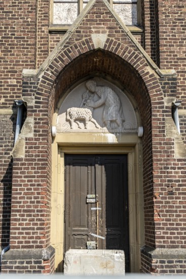 Church entrance with relief and locked door, Manheim, North Rhine-Westphalia, Germany
