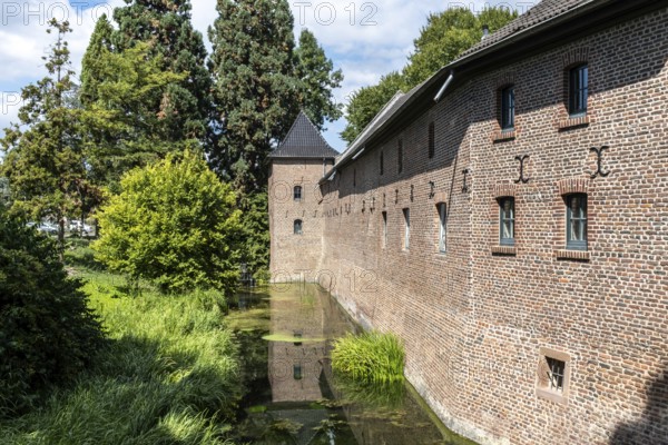 Brick façade of Paffendorf Castle with moat, Paffendorf, North Rhine-Westphalia, Germany