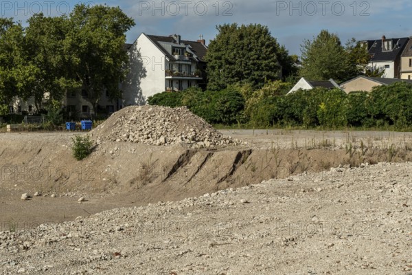 Extensive excavation pit with pile of stones, Ehrenfeld, Cologne, North Rhine-Westphalia, Germany
