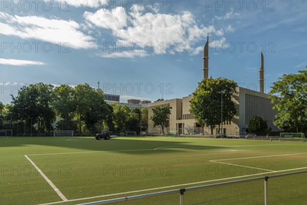 Football pitch with mosque in the background, Cologne, North Rhine-Westphalia, Germany