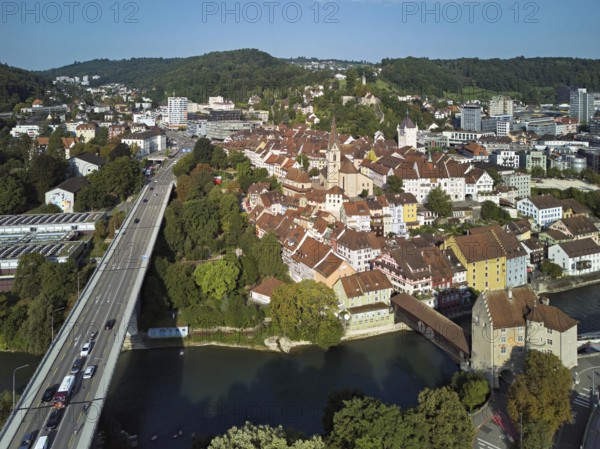 View of the old town with the parish church Maria Himmelfahrt, on the left the high bridge, behind the castle ruin Stein formerly an administrative centre of the Habsburgs, in front the river Limmat and the covered wooden bridge with the Landvogteischloss, Baden, Canton, Aargau, Switzerland
