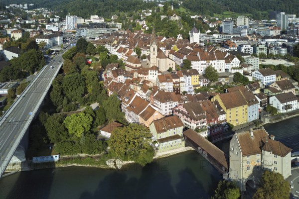 View of the old town with the parish church Maria Himmelfahrt, on the left the high bridge, behind the castle ruin Stein formerly an administrative centre of the Habsburgs, in front the river Limmat and the covered wooden bridge with the Landvogteischloss, Baden, Canton, Aargau, Switzerland