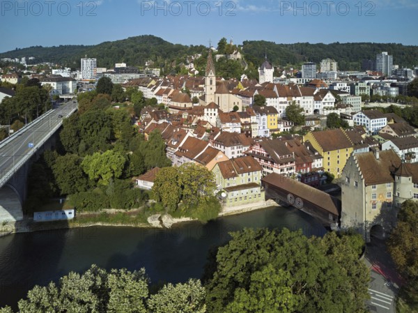 View of the old town with the parish church Maria Himmelfahrt, on the left the high bridge, behind the castle ruin Stein formerly an administrative centre of the Habsburgs, in front the river Limmat and the covered wooden bridge with the Landvogteischloss, Baden, Canton, Aargau, Switzerland