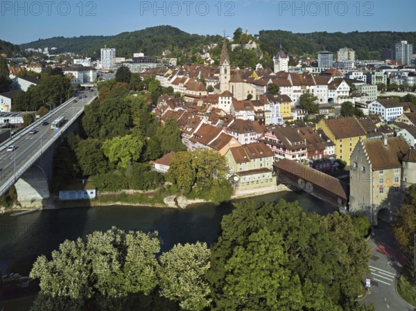 View of the old town with the parish church Maria Himmelfahrt, on the left the high bridge, behind the castle ruin Stein formerly an administrative centre of the Habsburgs, in front the river Limmat and the covered wooden bridge with the Landvogteischloss, Baden, Canton, Aargau, Switzerland