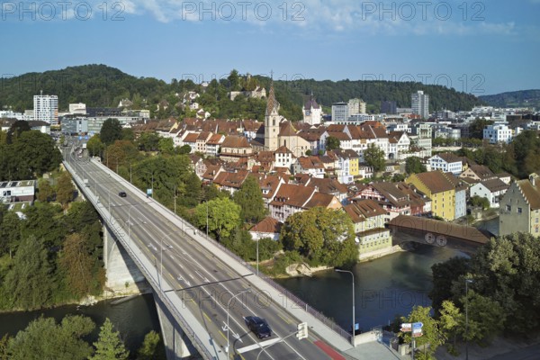 View of the old town with the parish church of Maria Himmelfahrt, in the foreground the high bridge, in the background the ruins of Stein Castle formerly an administrative centre of the Habsburgs, on the right the river Limmat and the covered wooden bridge with the Landvogteischloss, Baden, Canton, Aargau, Switzerland