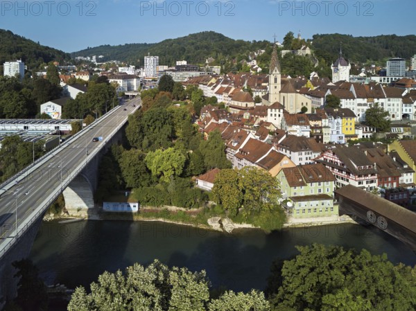 View of the old town with the parish church Maria Himmelfahrt, on the left the high bridge, behind the castle ruins Stein formerly an administrative centre of the Habsburgs, in front the river Limmat and the covered wooden bridge, Baden, Canton, Aargau, Switzerland