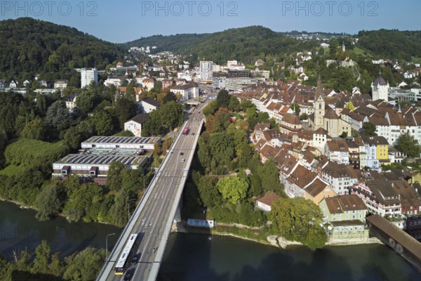 View of the old town with the parish church Maria Himmelfahrt, on the left the high bridge, behind the castle ruins Stein formerly an administrative centre of the Habsburgs, in front the river Limmat and the covered wooden bridge, Baden, Canton, Aargau, Switzerland