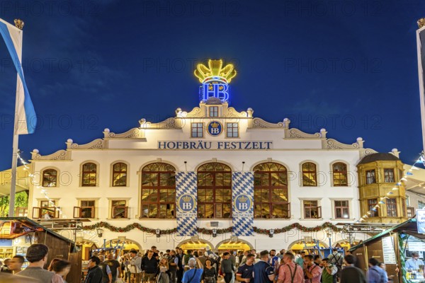 The Hofbräu marquee at Oktoberfest 2024 at dusk, Munich, Bavaria, Germany