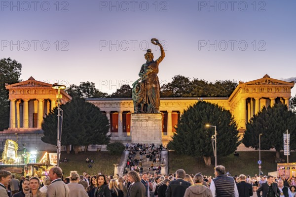 Ruhmeshalle, Bavaria statue and visitors at the Oktoberfest 2024 at dusk, Munich, Bavaria, Germany