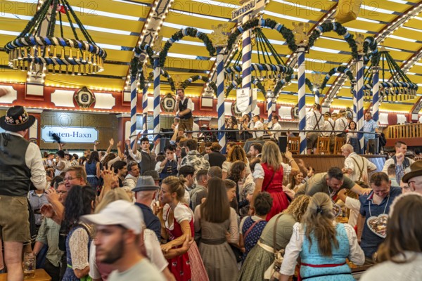 Visitors and band in the Löwenbräu marquee at the Oktoberfest 2024 in Munich, Bavaria, Germany