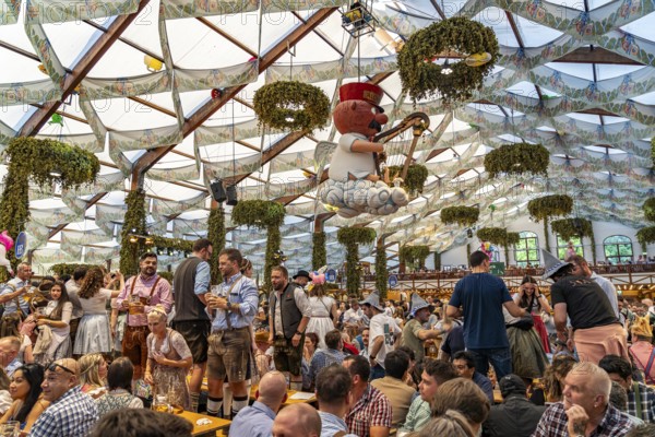 Visitors in the Hofbräu marquee at the Oktoberfest 2024 in Munich, Bavaria, Germany