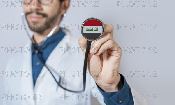 Doctor holding stethoscope with Iraq flag. Iraq health and care concept, Iraq flag on stethoscope