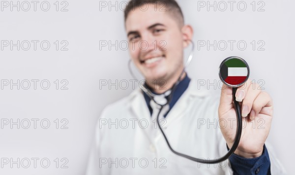 Doctor showing stethoscope with Kuwait flag. Kuwait national healthcare concept