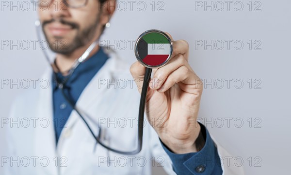 Doctor holding stethoscope with Kuwait flag. Kuwait health and care concept, Kuwait flag on stethoscope