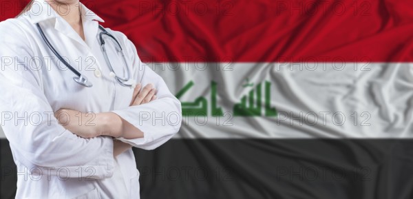 Doctor with crossed arms on Iraq flag. Iraq health and care concept. Female doctor on Iraq flag