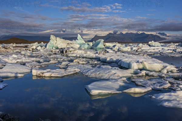 Icebergs, ice floes, lake, glacier lagoon, glacier, mountains, clouds, summer, morning mood, reflection, Jökulsarlon, Vatnajökull National Park, Iceland