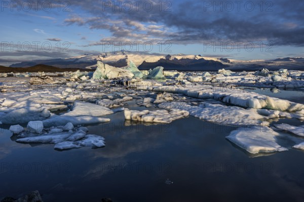 Icebergs, ice floes, lake, glacier lagoon, glacier, mountains, clouds, summer, morning mood, reflection, Jökulsarlon, Vatnajökull National Park, Iceland