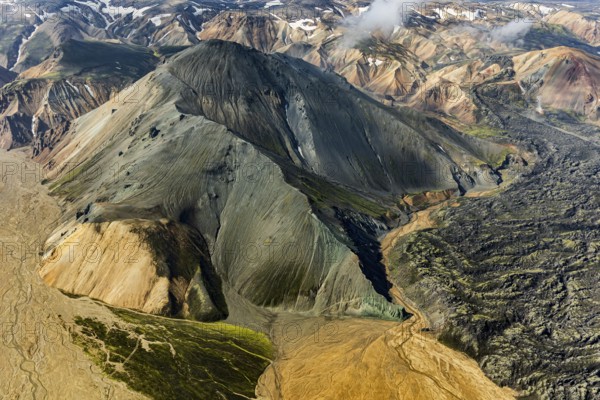 Mountain landscape, sunny, summer, snowfields, lava field, volcanic landscape, aerial view, Landmannalaugar, Fjallabak Nature Reserve, Icelandic Highlands, Iceland