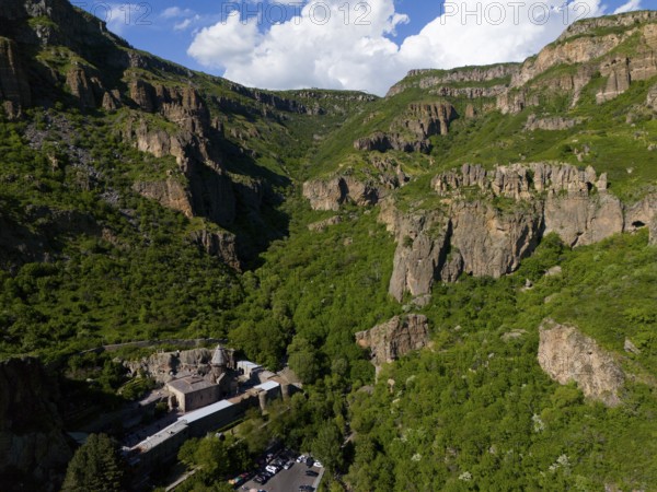 Gorge with lush greenery and rocks under a blue sky with clouds, aerial view, Geghard Monastery, UNESCO World Heritage Site, Kotayk Province, Armenia