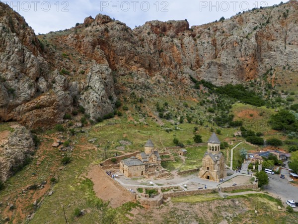Historic churches embedded in a rocky mountain landscape, surrounded by green vegetation and quietly secluded, aerial view, Noravank Monastery, Surb Astvatsatsin mausoleum church on the right and Surb Karapet Anabaptist church on the left, Noravank, Vayots Dzor province, Vayots Dzor, Armenia, Caucasus