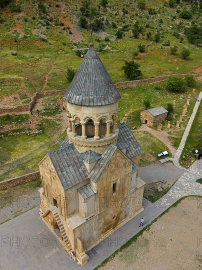 Old stone church with tower in mountainous landscape and green areas, aerial view, Noravank monastery, mausoleum church Surb Astvatsatsin, Noravank, Vayots Dzor province, Vayots Dzor, Armenia, Caucasus