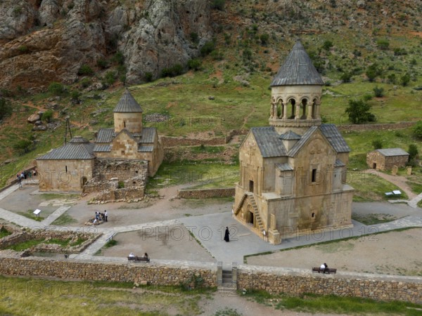 Old church in rural area with stone buildings and green landscape surrounded by mountains, aerial view, Noravank monastery, on the right mausoleum church Surb Astvatsatsin and on the left Baptist church Surb Karapet, Noravank, Vayots Dzor province, Vayots Dzor, Armenia, Caucasus