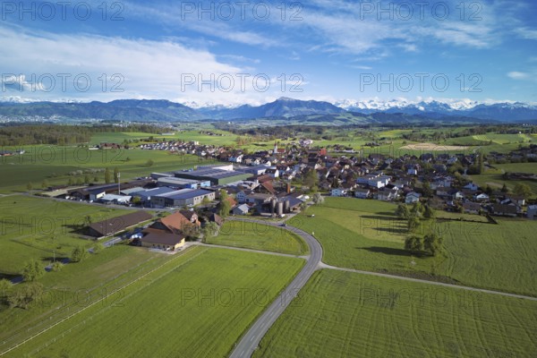 View of the village, in the foreground the industrial area, in the background the Rigi and the snow-covered Alps, Auw, Freiamt, Canton, Aargau, Switzerland
