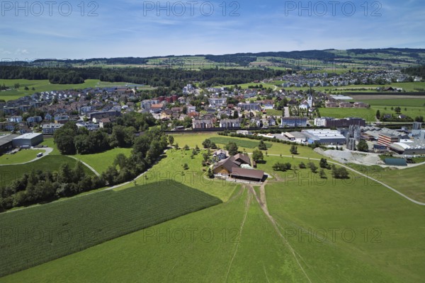 View of the village with the catholic parish church Mariä Geburt, on the right the industrial area, behind the Lindenberg, Sins, Freiamt, Canton, Aargau, Switzerland